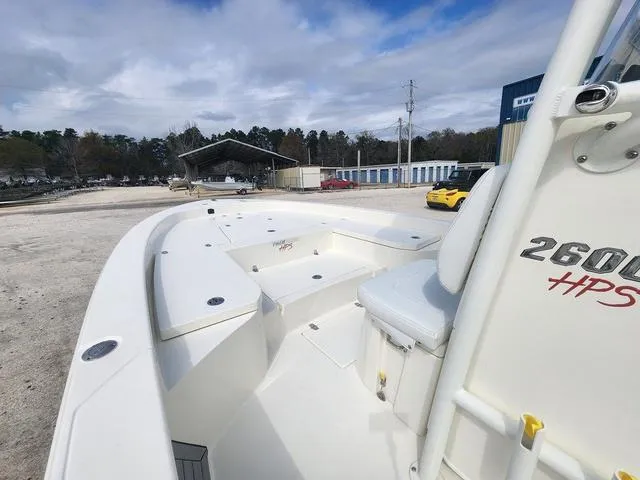 Slide: The Image of 2024 Pathfinder 2600 HPS boat, white interior, outdoor storage area, cloudy sky. - 19