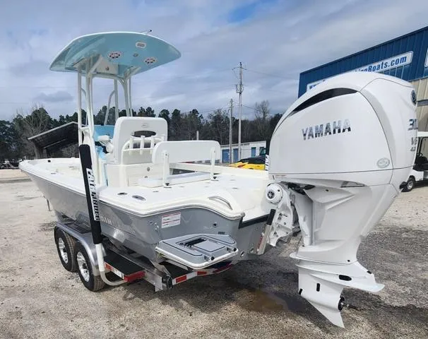 Slide: The Image of 2024 Pathfinder 2600 HPS boat with Yamaha engine on a trailer, parked outdoors. - 4