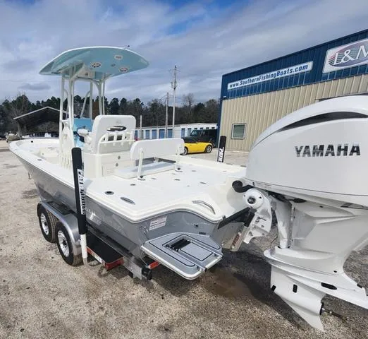 Slide: The Image of 2024 Pathfinder 2600 HPS boat with Yamaha engine on trailer, parked outdoors. - 5