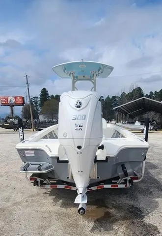 Slide: The Image of 2024 Pathfinder 2600 HPS boat with powerful outboard motor, parked outdoors. - 6