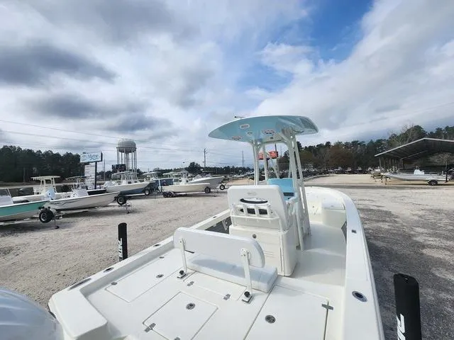 Slide: The Image of 2024 Pathfinder 2600 HPS boat in a dealership lot under a cloudy sky. - 8