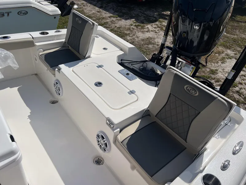 Slide: The Image of 2025 Key West 230 Bay Reef boat interior with cushioned seats and storage compartments. - 11