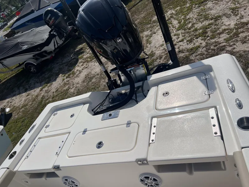 Slide: The Image of 2025 Key West 230 Bay Reef boat with outboard motor and storage compartments. - 12