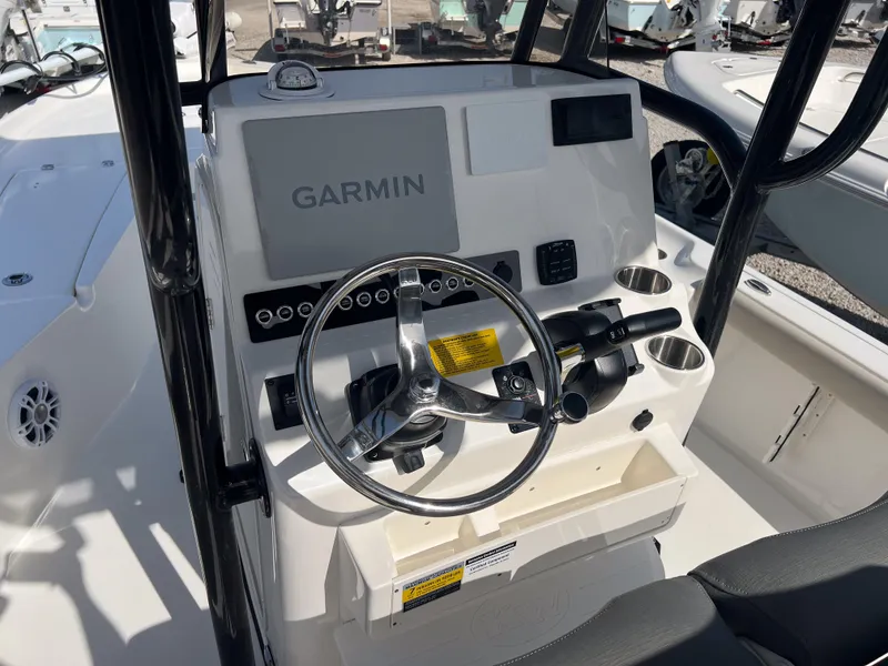 Slide: The Image of Key West 230 Bay Reef 2025 boat console with Garmin navigation system and steering wheel. - 15
