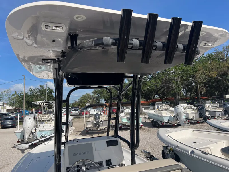 Slide: The Image of 2025 Key West 230 Bay Reef boat with T-top and rod holders in a marina. - 16