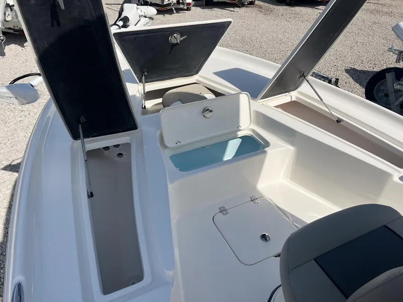 Slide: The Image of 2025 Key West 230 Bay Reef boat interior with open storage compartments. - 19