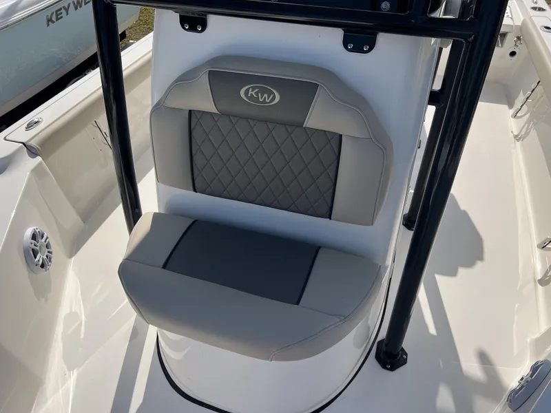Slide: The Image of 2025 Key West 230 Bay Reef boat seat with gray cushioned design. - 22