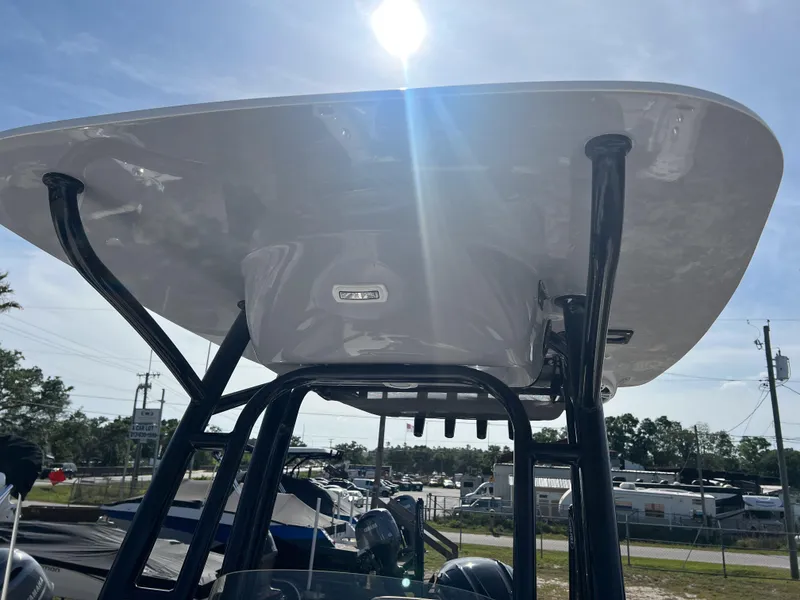 Slide: The Image of 2025 Key West 230 Bay Reef boat with T-top under sunlight. - 24