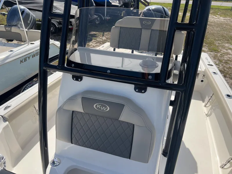 Slide: The Image of 2025 Key West 230 Bay Reef boat interior with cushioned seating and console. - 25