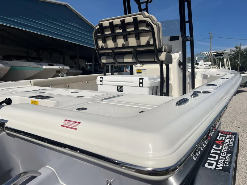 Slide: The Image of 2025 Key West 230 Bay Reef boat with seating and storage, displayed outdoors. - 6