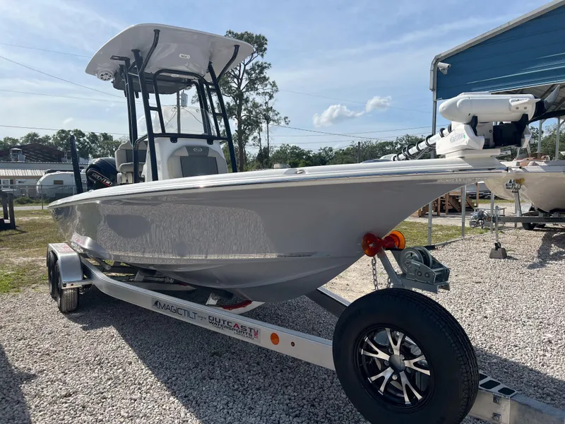 Slide: The Image of 2025 Key West 230 Bay Reef boat on trailer, parked outdoors under clear sky. - 7