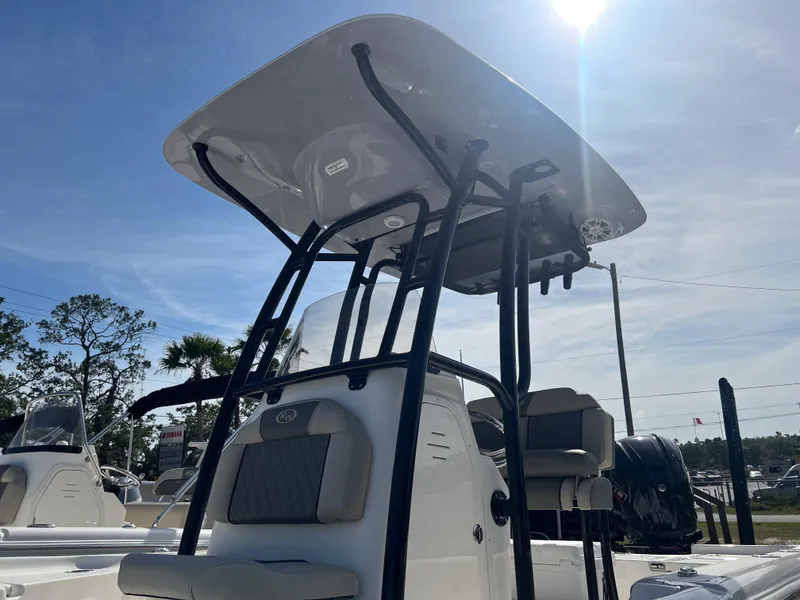 Slide: The Image of 2025 Key West 230 Bay Reef boat with T-top under sunny sky. - 9