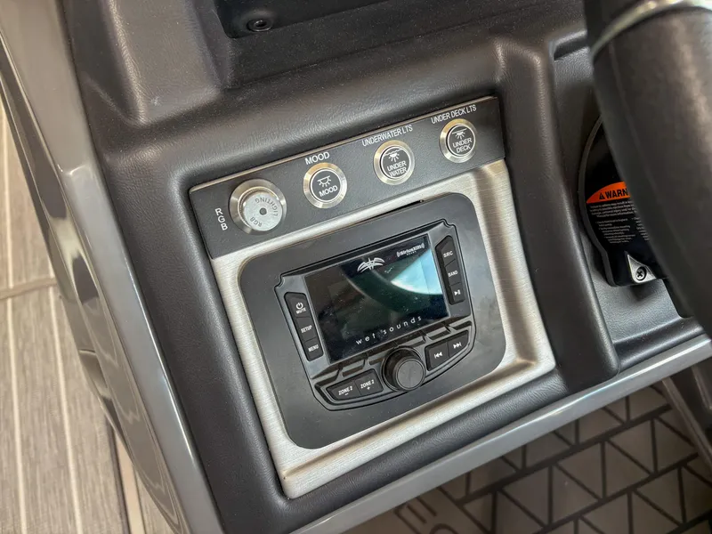 Slide: The Image of Control panel of 2025 Trifecta 23 RF SS boat with audio system and switches. - 10
