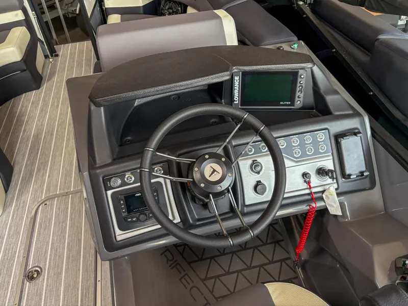 Slide: The Image of 2025 Trifecta 23 RF SS boat dashboard with steering wheel and control panel. - 12