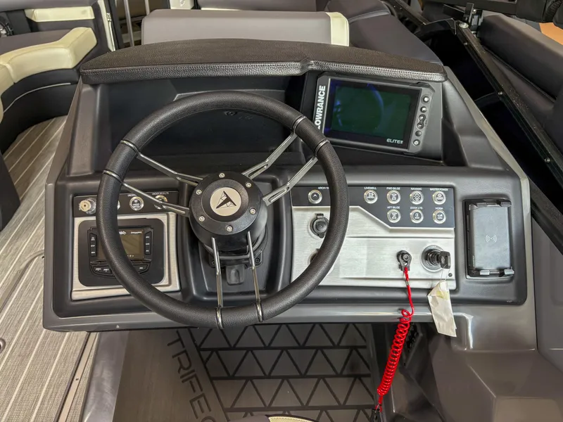 Slide: The Image of 2025 Trifecta 23 RF SS boat dashboard with steering wheel and control panel. - 13