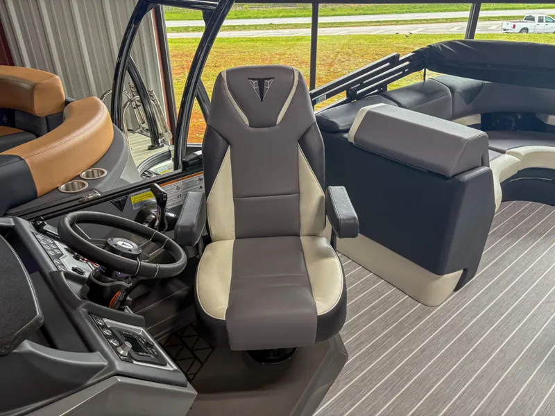 Slide: The Image of 2025 Trifecta 23 RF SS boat interior with captain's chair and steering wheel. - 7