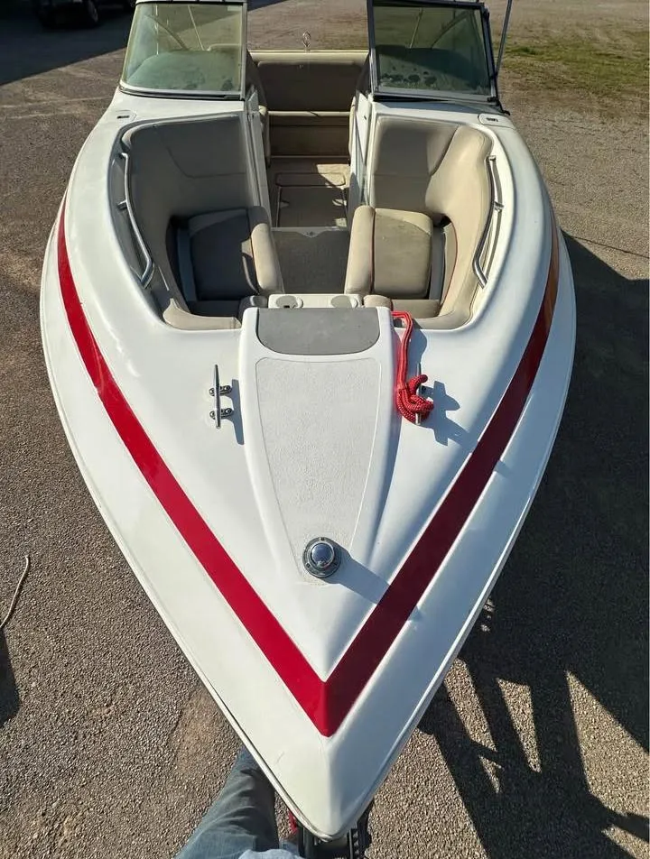 Slide: The Image of 1997 Cobalt 220 boat with red stripe, open bow seating, and dual windshields. - 3