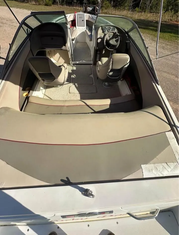 Slide: The Image of 1997 Cobalt 220 boat interior with beige seating and steering console. - 5