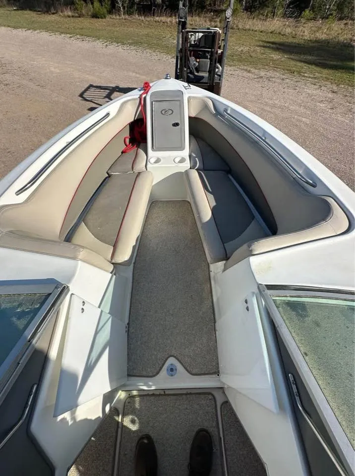Slide: The Image of 1997 Cobalt 220 boat interior with beige seating and carpeted floor. - 7