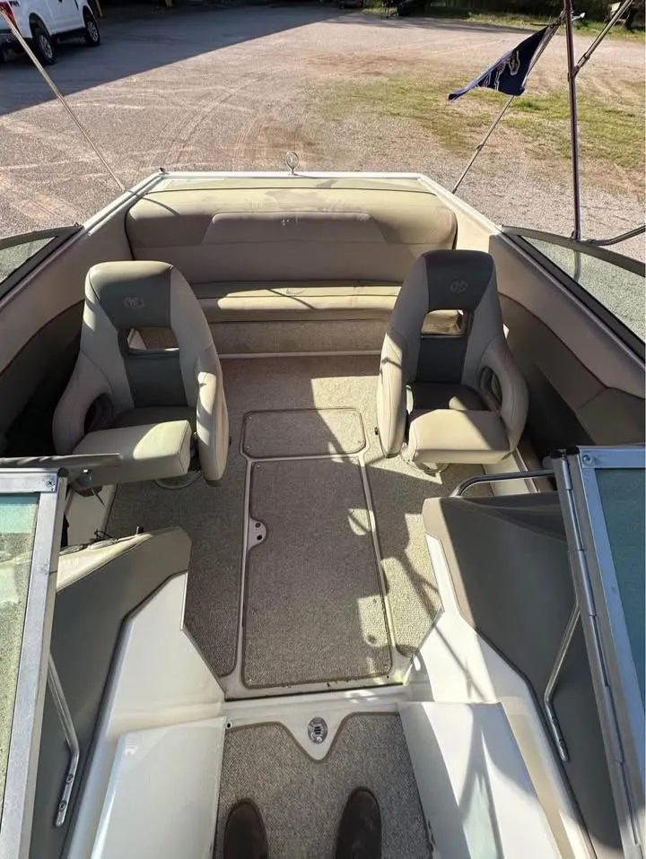 Slide: The Image of 1997 Cobalt 220 boat interior with beige seating and carpeted floor. - 8