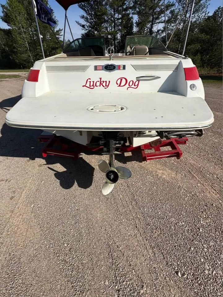 Slide: The Image of 1997 Cobalt 220 boat named "Lucky Dog" on a trailer, rear view. - 9