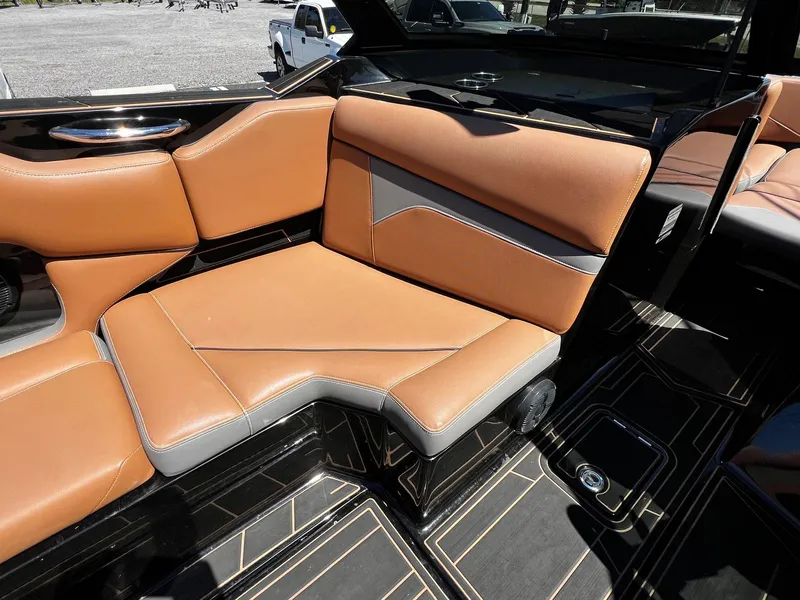 Slide: The Image of 2019 Supreme ZS232 boat interior with tan and gray seating, modern design. - 13