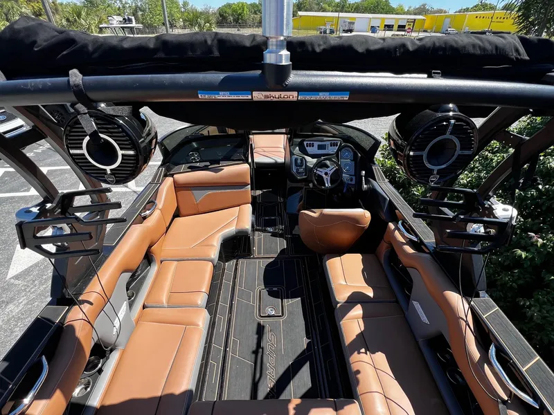 Slide: The Image of 2019 Supreme ZS232 boat interior with tan leather seats and advanced audio system. - 14