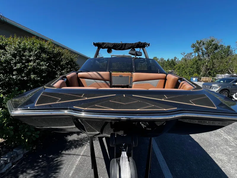 Slide: The Image of 2019 Supreme ZS232 boat with sleek design and luxurious interior, parked outdoors. - 4