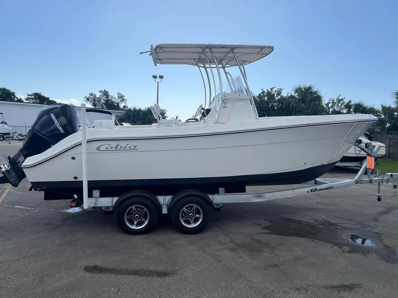 Slide: The Image of 2022 Cobia 237 Center Console boat on trailer, side view. - 2