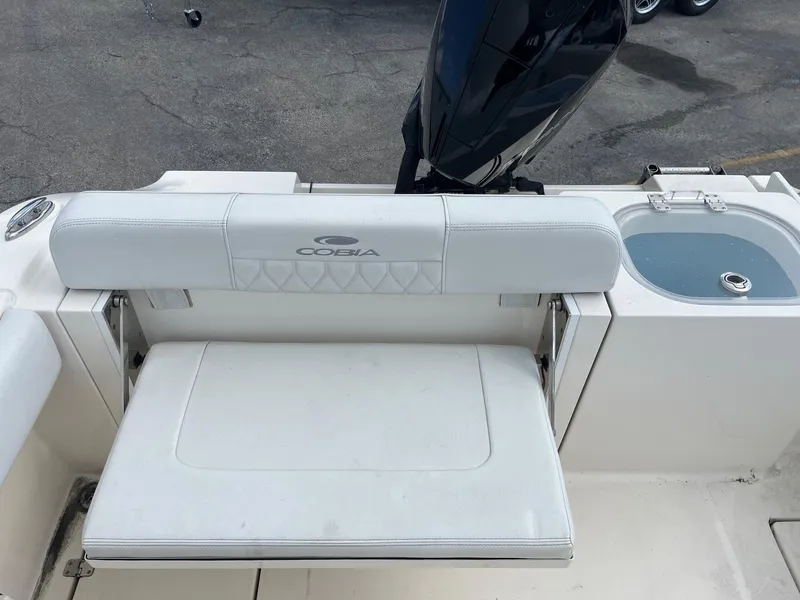 Slide: The Image of 2022 Cobia 237 Center Console boat with white seating and integrated livewell. - 4