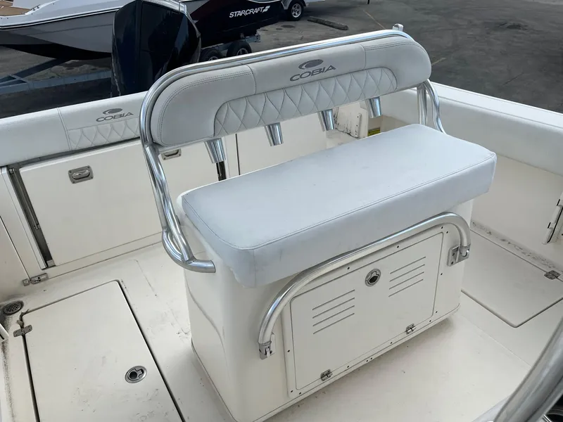 Slide: The Image of 2022 Cobia 237 Center Console boat interior with cushioned seating and storage. - 6
