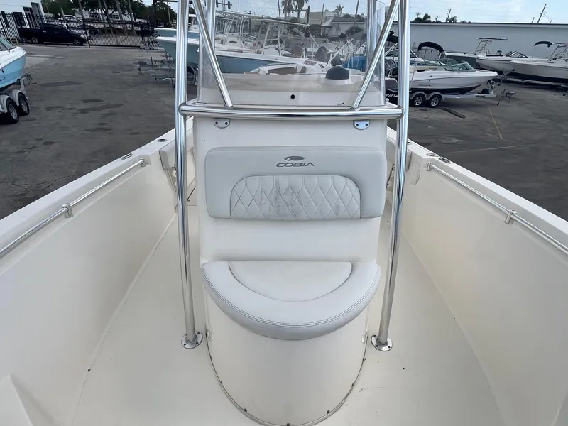 Slide: The Image of 2022 Cobia 237 Center Console boat with cushioned seating and stainless steel railings. - 7