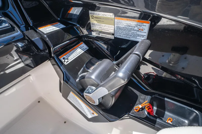 Slide: The Image of Control panel of 2015 Yamaha Boats 242 Limited S with throttle and safety warnings. - 10