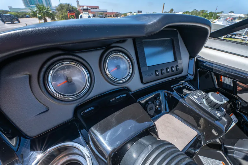 Slide: The Image of Dashboard of 2015 Yamaha Boats 242 Limited S with gauges and controls. - 11