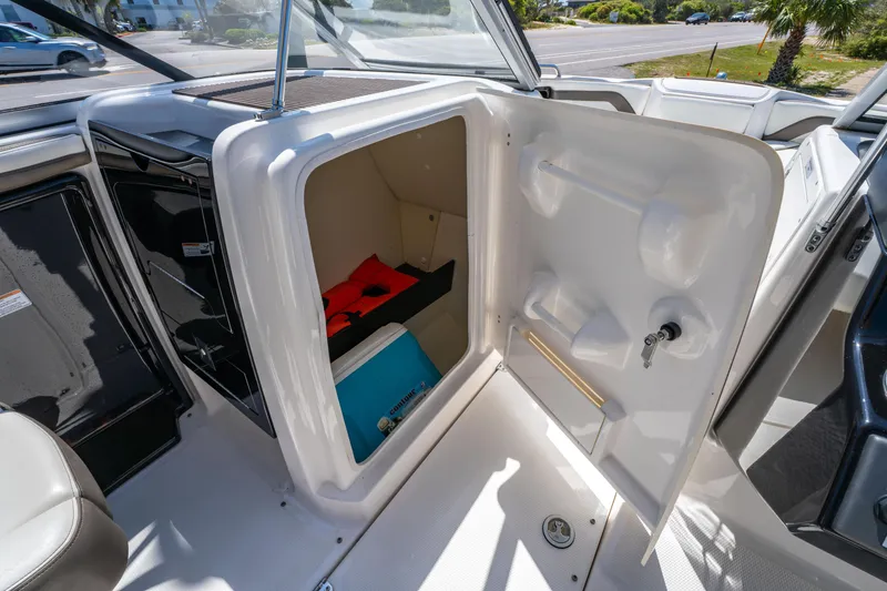 Slide: The Image of 2015 Yamaha Boats 242 Limited S storage compartment with life jackets and equipment. - 18
