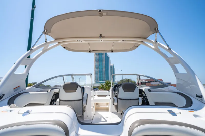 Slide: The Image of 2015 Yamaha Boats 242 Limited S interior with canopy, city skyline in background. - 6