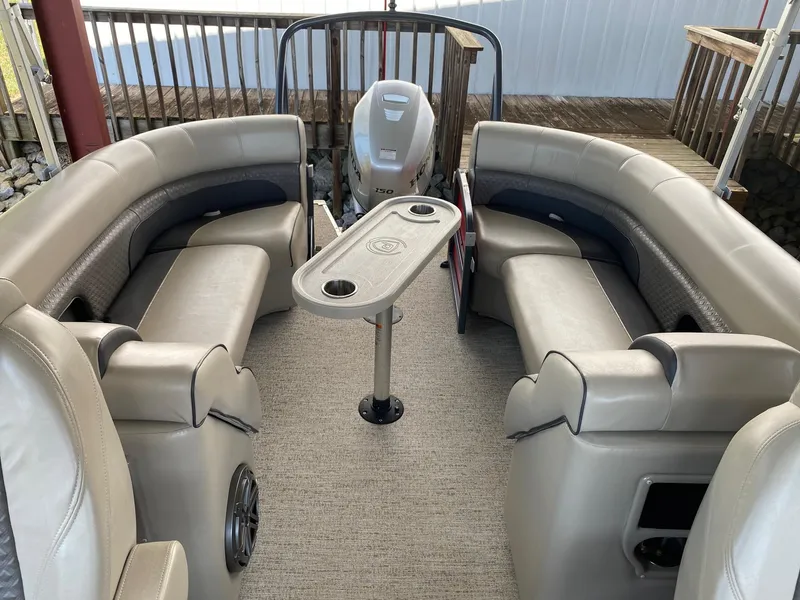 Slide: The Image of 2021 Premier 230 Solaris RF boat interior with beige seating and central table. - 6