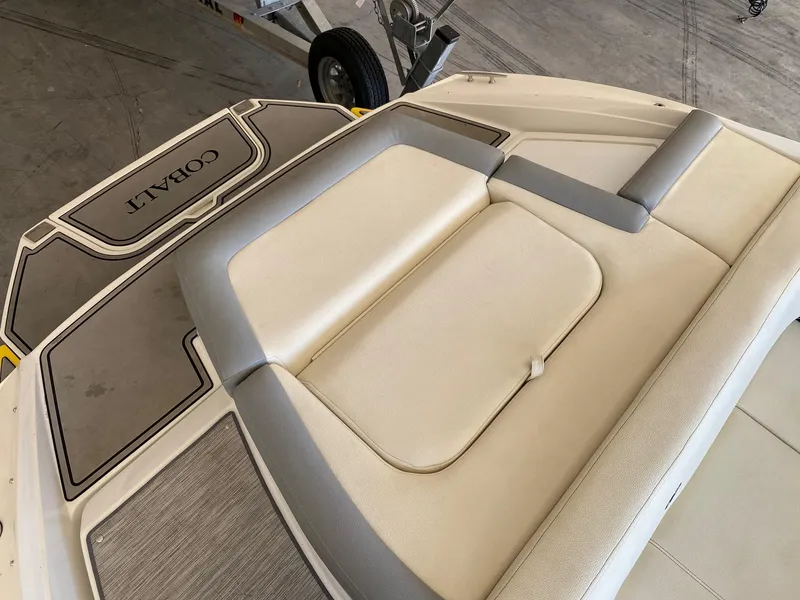 Slide: The Image of 2022 Cobalt CS23 Surf boat with beige seating and deck view. - 4