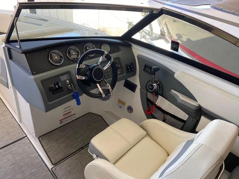 Slide: The Image of 2022 Cobalt CS23 Surf boat interior with steering wheel and dashboard controls. - 5
