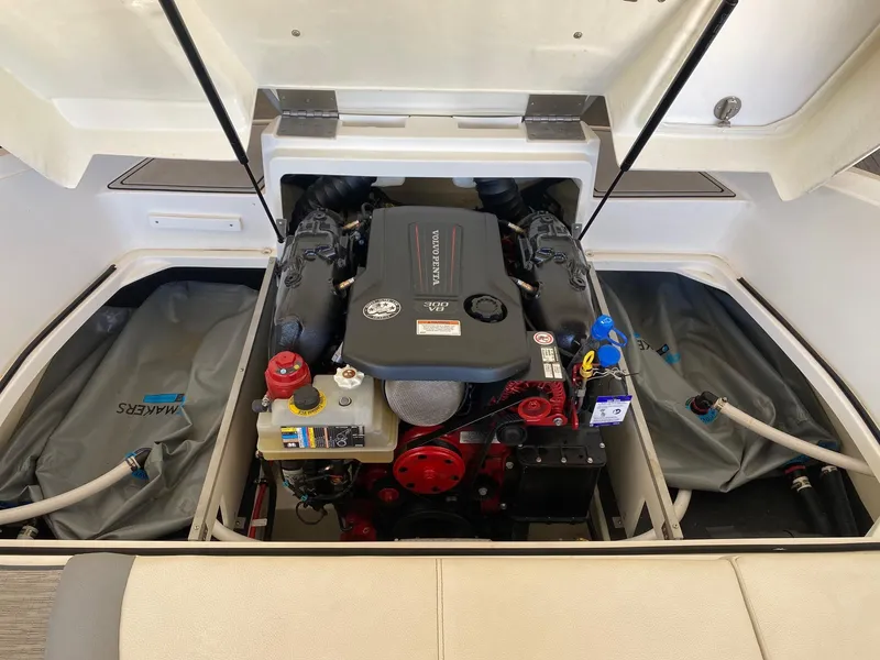 Slide: The Image of 2022 Cobalt CS23 Surf boat engine compartment with visible components and wiring. - 9