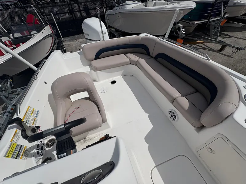 Slide: The Image of 2014 Hurricane SunDeck Sport 232 OB boat interior with seating and steering console. - 4