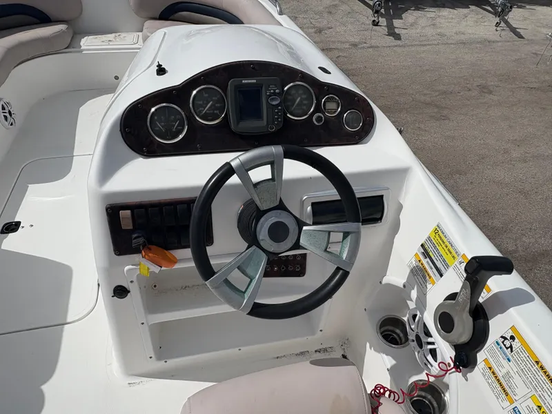 Slide: The Image of 2014 Hurricane SunDeck Sport 232 OB boat dashboard with steering wheel and gauges. - 6