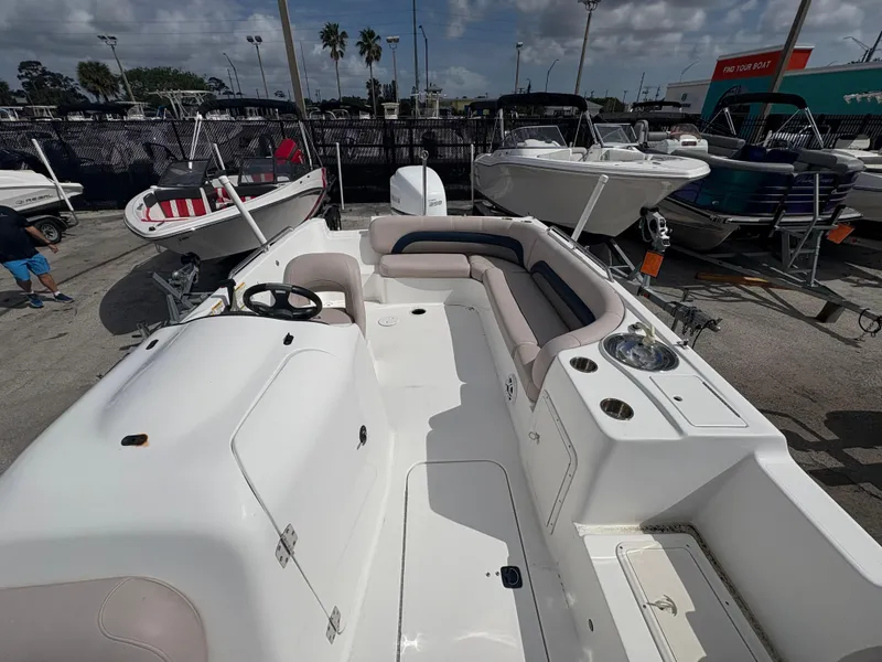 Slide: The Image of 2014 Hurricane SunDeck Sport 232 OB boat with spacious seating and steering console. - 7