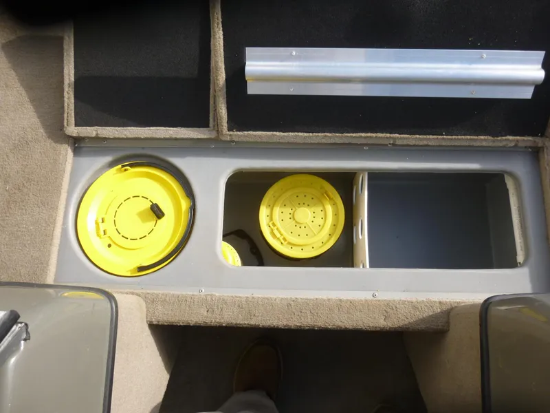 Slide: The Image of 2004 Bass Tracker Targa 16 WT boat storage compartments with yellow lids. - 17