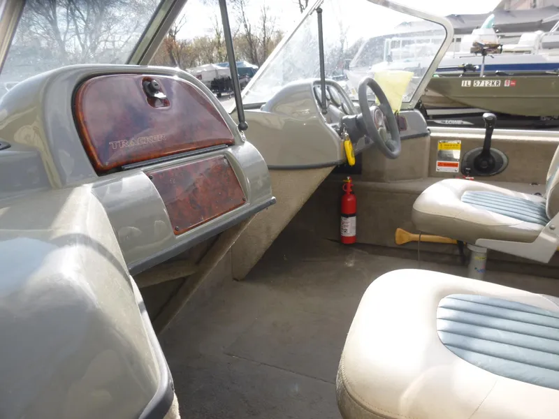 Slide: The Image of 2004 Bass Tracker Targa 16 WT boat interior with steering wheel and seats. - 19