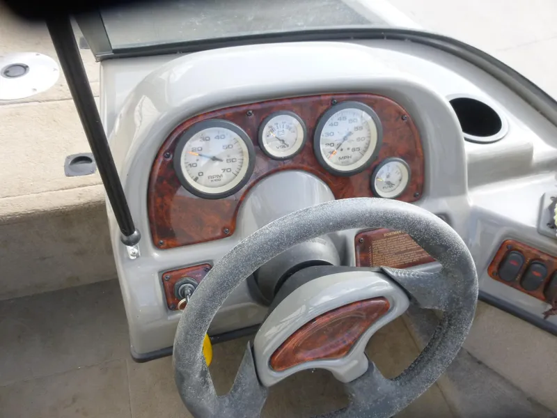 Slide: The Image of Dashboard of 2004 Bass Tracker Targa 16 WT boat with steering wheel and gauges. - 24
