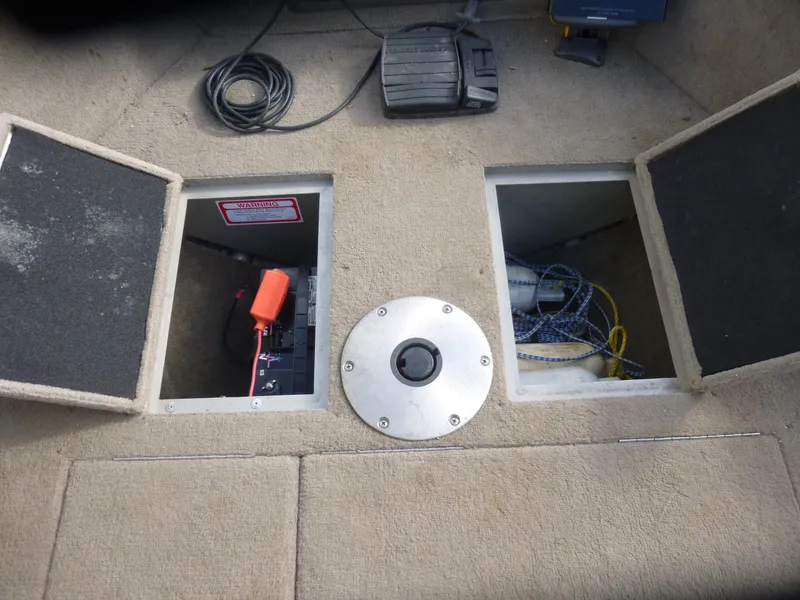 Slide: The Image of 2004 Bass Tracker Targa 16 WT boat interior with storage compartments and pedal. - 27