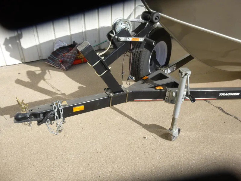 Slide: The Image of 2004 Bass Tracker Targa 16 WT trailer hitch and wheel on concrete surface. - 33