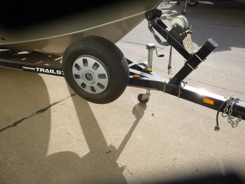 Slide: The Image of Trailer hitch and wheel of 2004 Bass Tracker Targa 16 WT boat on pavement. - 34