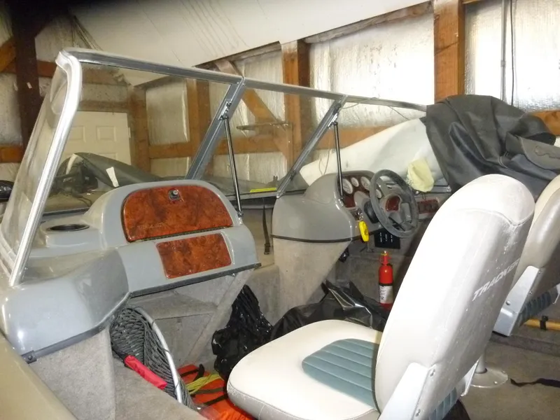 Slide: The Image of 2004 Bass Tracker Targa 16 WT boat interior with seats and dashboard in a garage. - 7